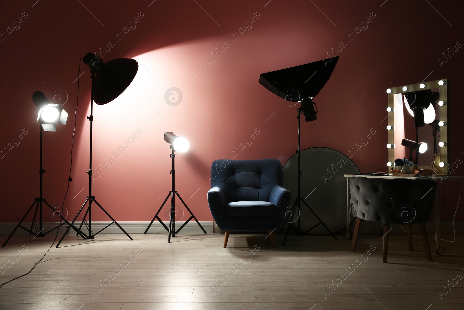 Photo of Different professional lighting equipment in modern photo studio