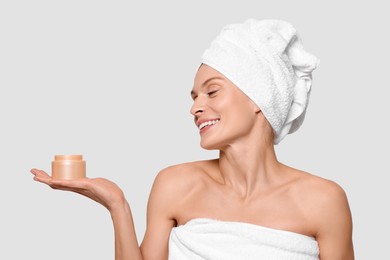 Photo of Woman with jar of body cream on white background