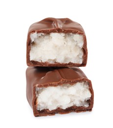 Photo of Halves of delicious milk chocolate candy bar with coconut filling on white background