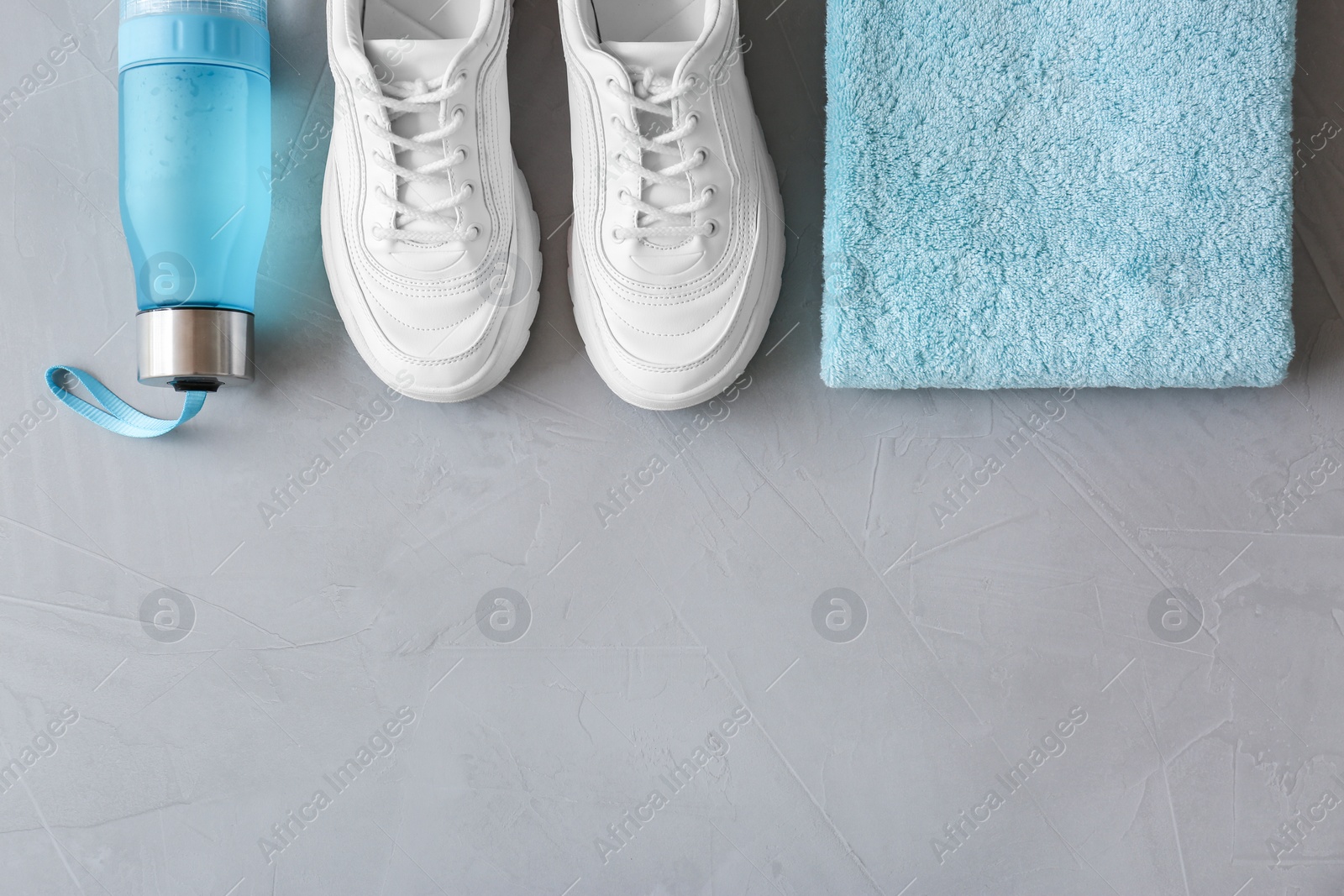 Photo of Flat lay composition with fitness equipment and space for text on gray background