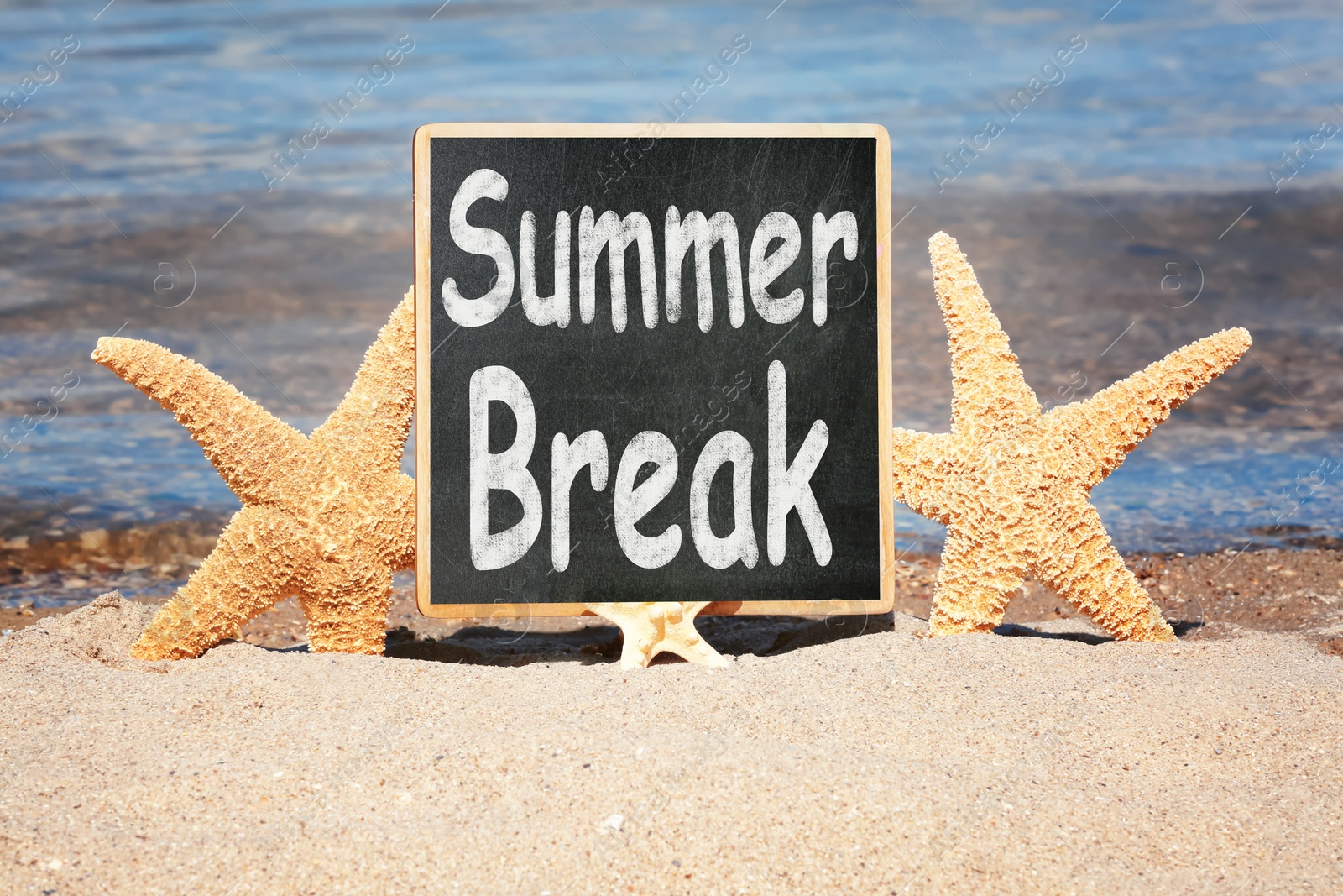 Image of Small chalkboard with inscription Summer Break on sand near sea. School Holidays 