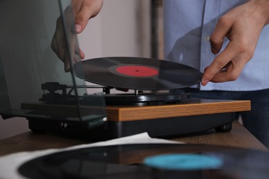 Photo of Man using turntable at home, closeup view