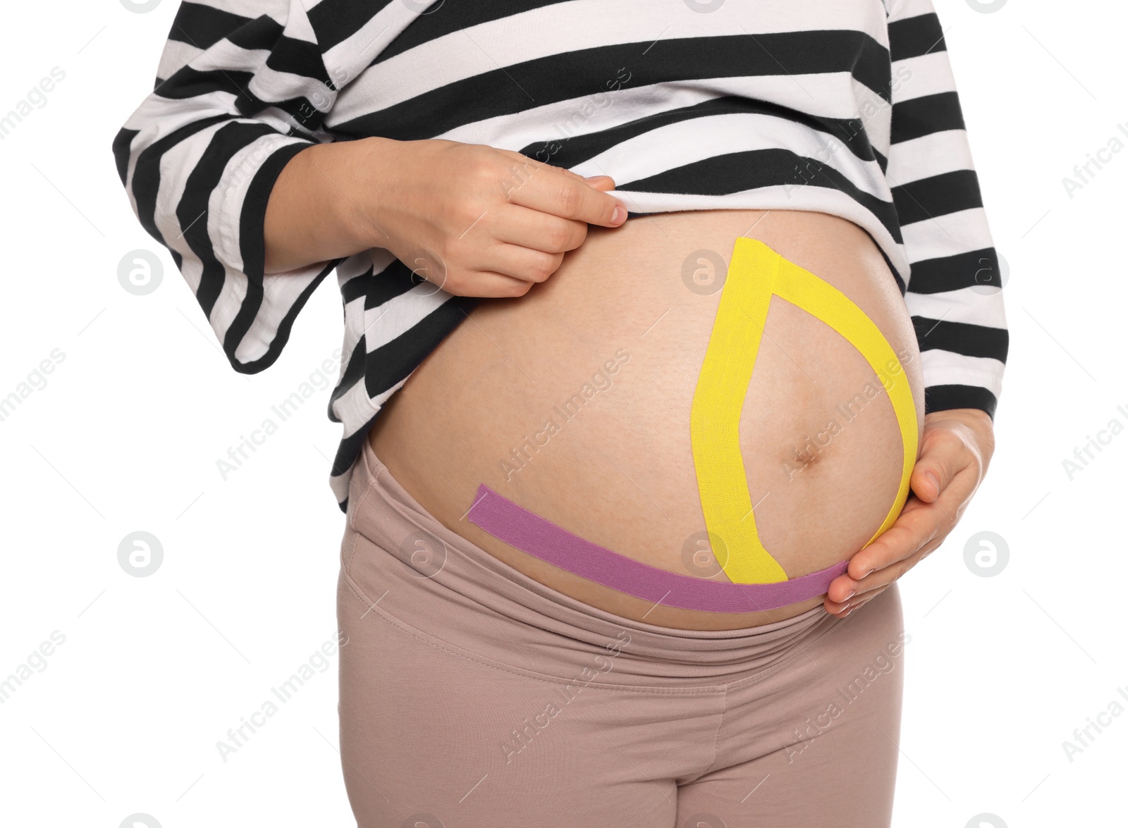 Photo of Pregnant woman with kinesio tapes on her belly against white background, closeup