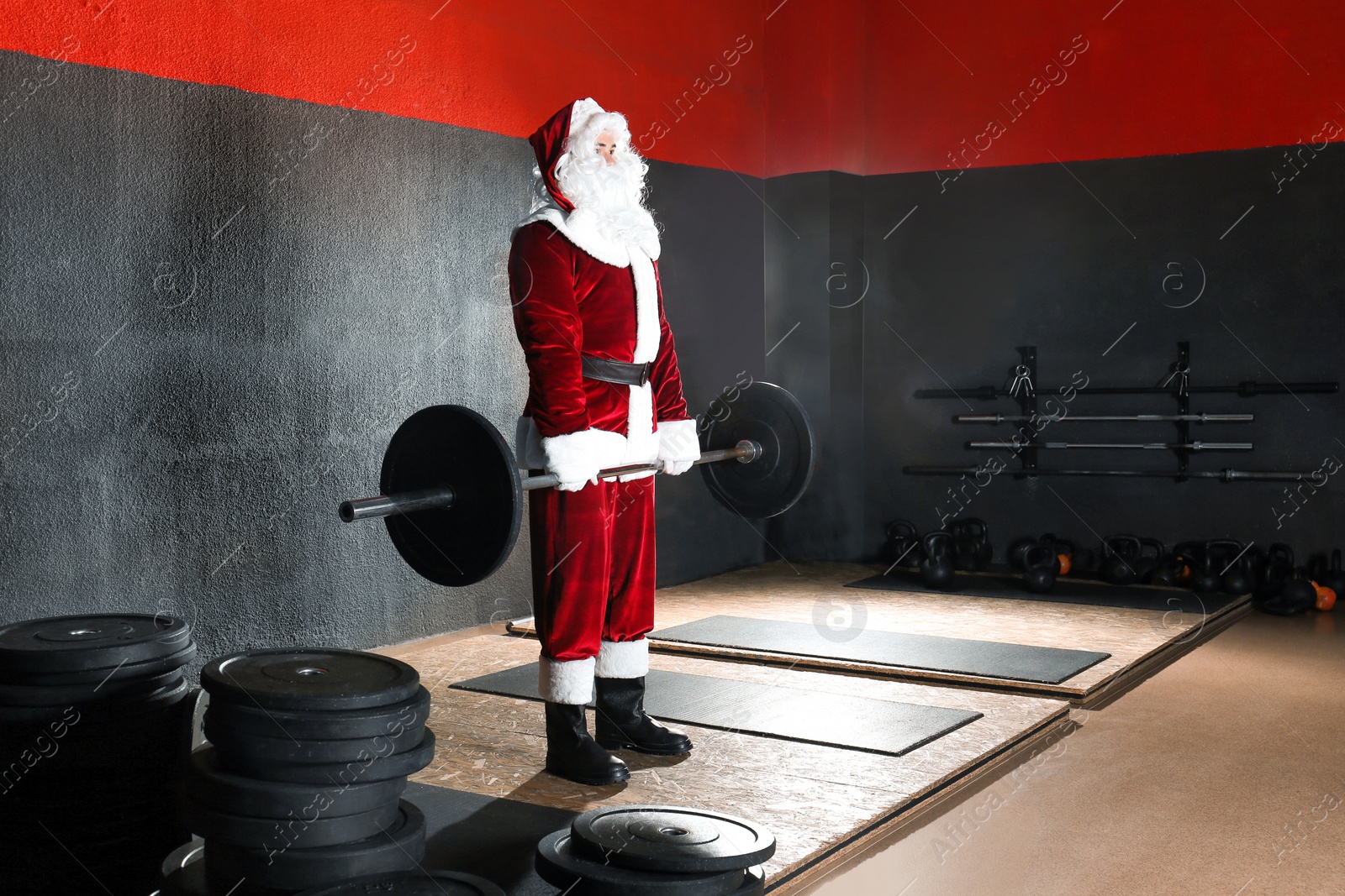 Photo of Young Santa Claus training in modern gym