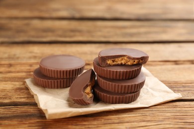 Delicious peanut butter cups on wooden table