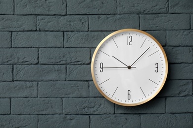 Modern clock on brick wall. Time concept