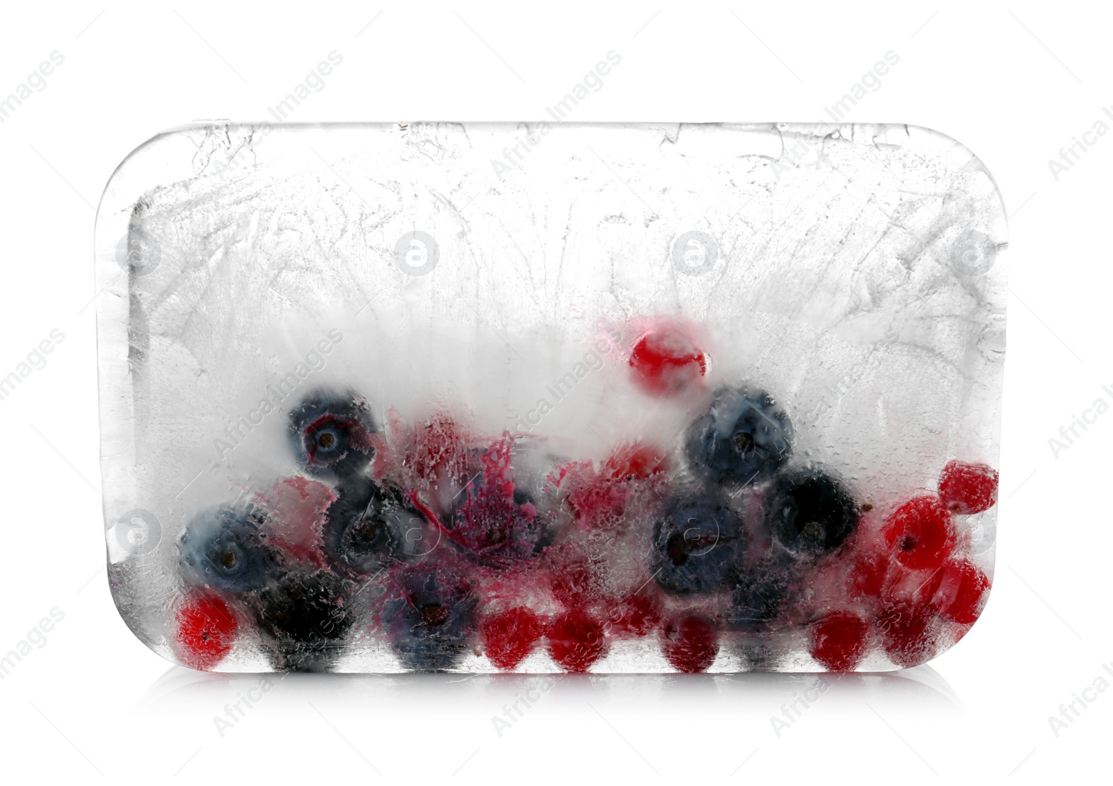 Photo of Raw berries frozen in ice cube on white background