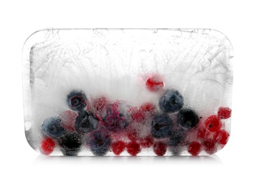 Photo of Raw berries frozen in ice cube on white background