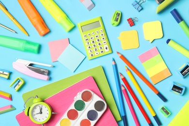 Photo of Different stationery on light blue background, flat lay. Back to school