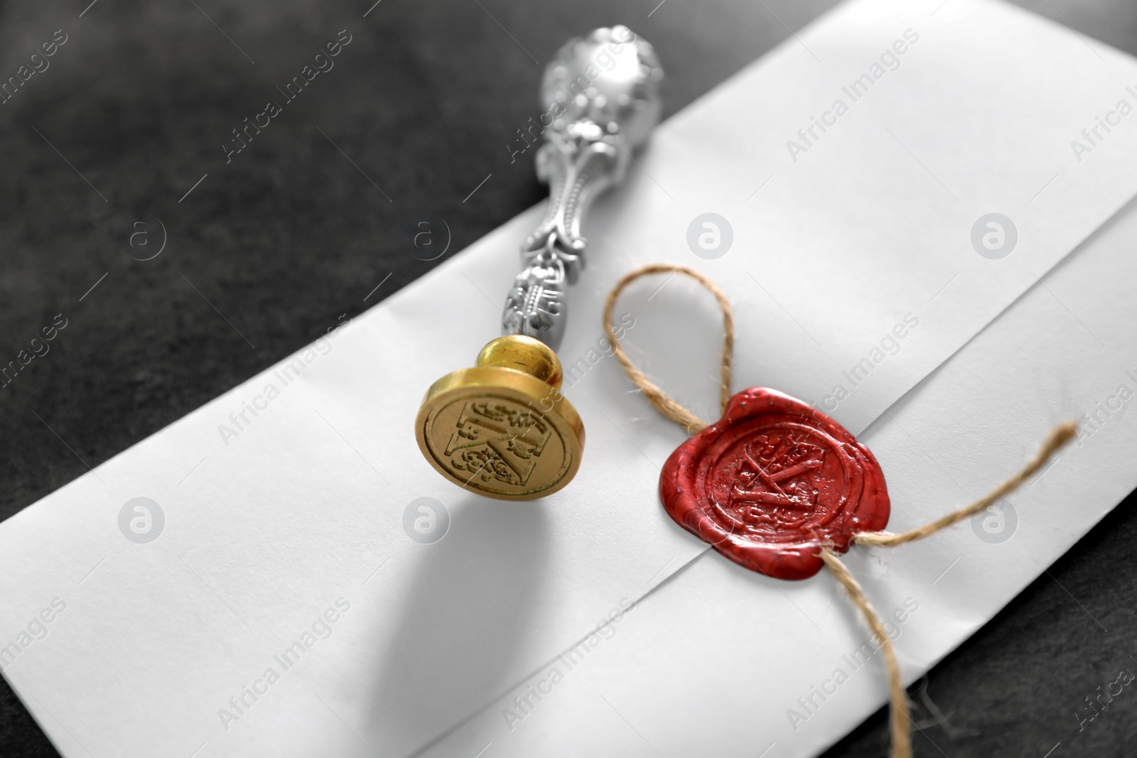 Photo of Vintage notary stamp and sealed document on grey background, closeup