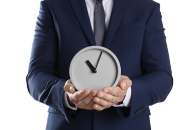 Photo of Young businessman holding clock on white background. Time management