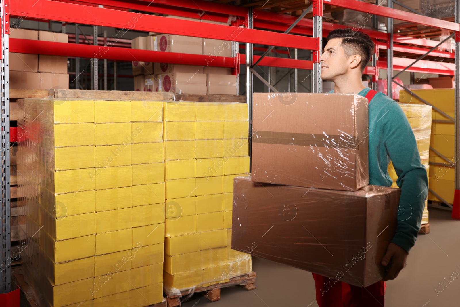 Photo of Worker with cardboard boxes in warehouse, space for text. Wholesaling