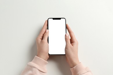 Photo of Woman with smartphone on white background, top view