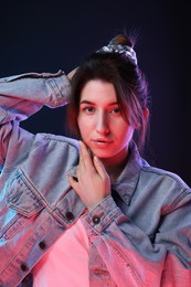 Portrait of beautiful young woman on color background