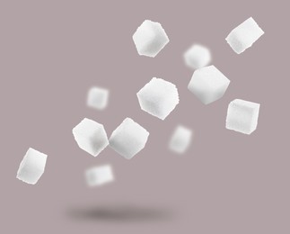 Image of Refined sugar cubes in air on grey background