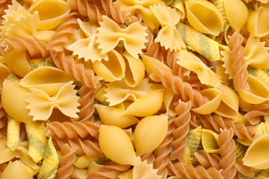 Photo of Different types of pasta as background, top view