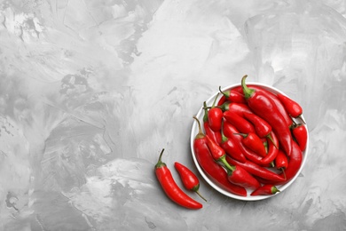 Photo of Flat lay composition with fresh chili peppers and space for text on table