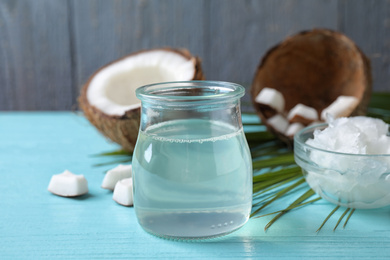Photo of Coconut oil on light blue wooden table