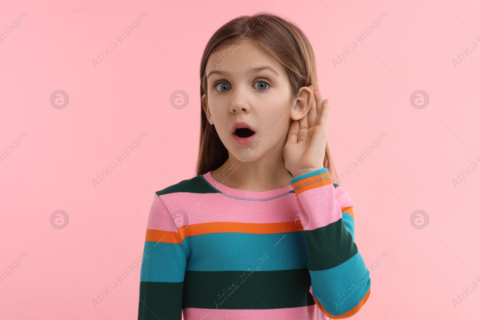 Photo of Little girl with hearing problem on pink background