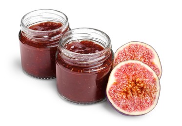 Glass jars of tasty sweet fig jam isolated on white