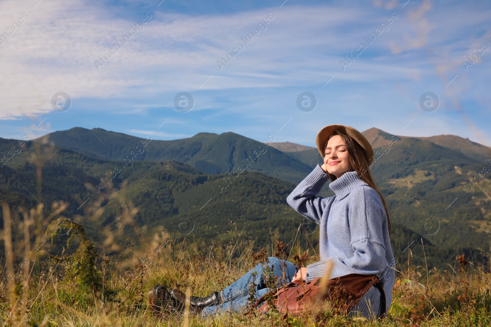 Photo of Young woman enjoying beautiful mountain landscape on sunny day