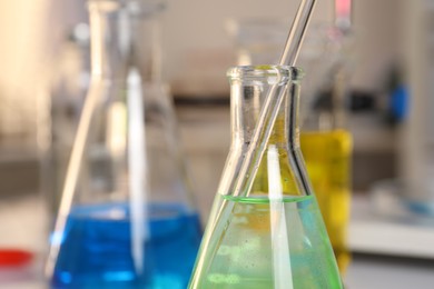 Laboratory analysis. Glassware with different liquids on table indoors, closeup