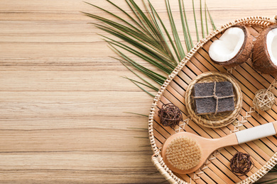 Photo of Flat lay composition with handmade soap on wooden background. Space for text