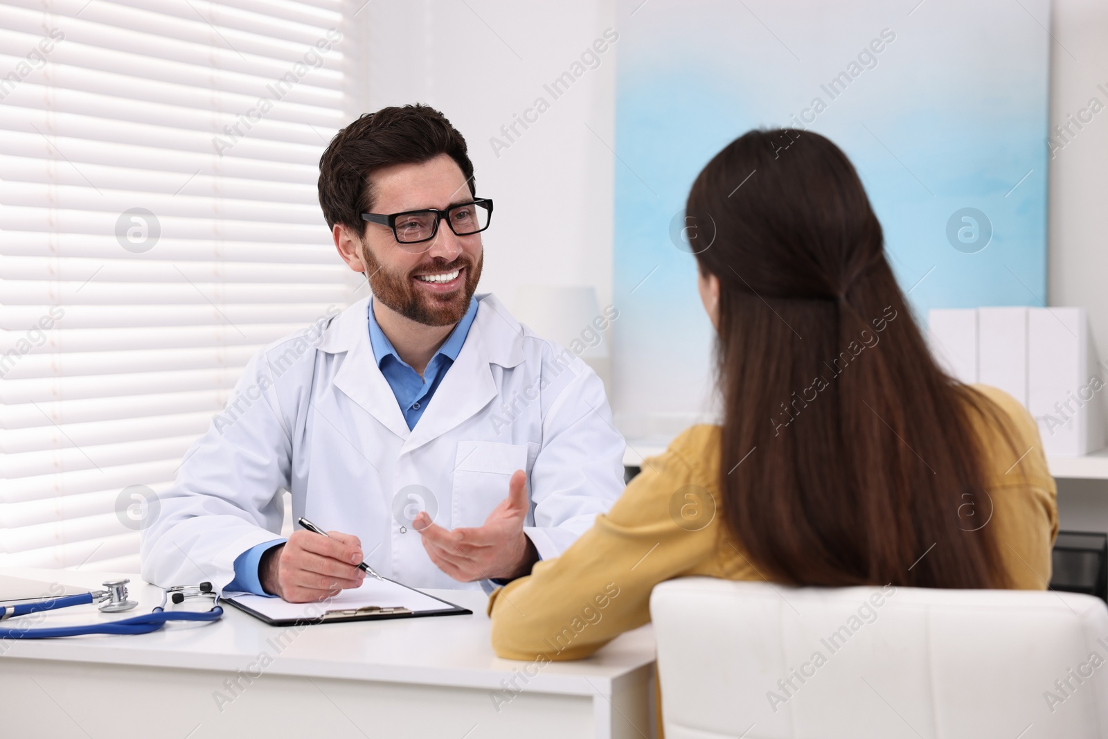 Photo of Doctor consulting patient during appointment in clinic