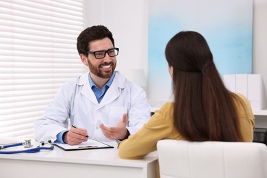 Doctor consulting patient during appointment in clinic