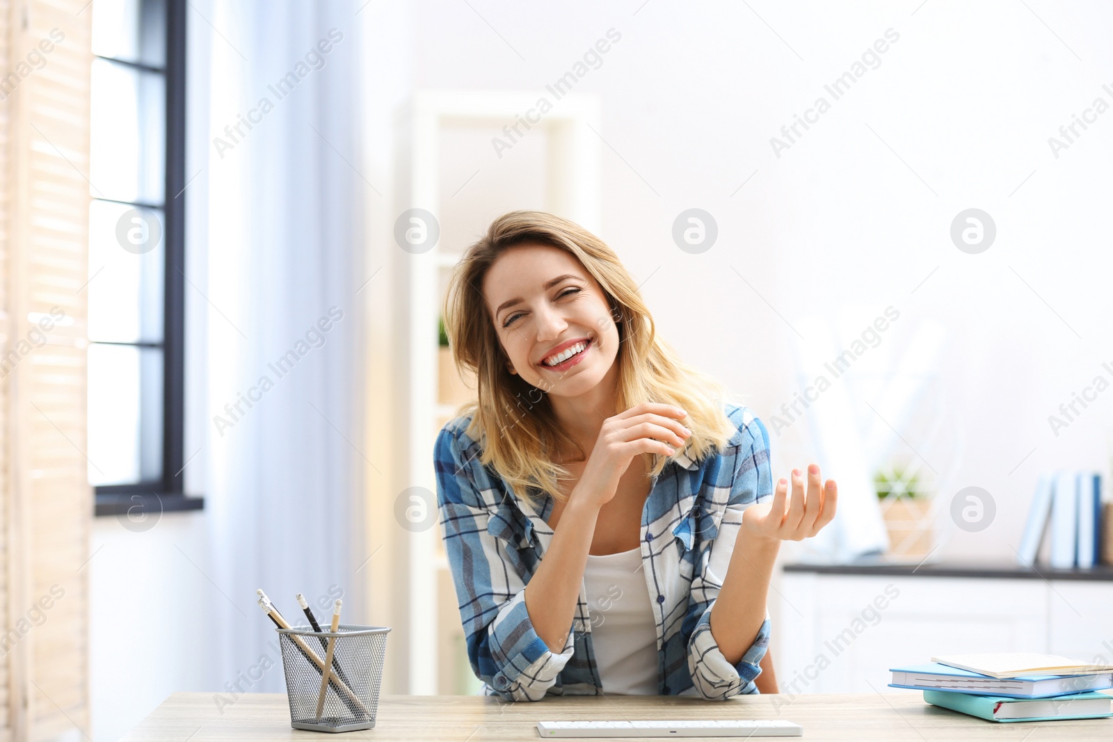 Photo of Beautiful woman using video chat for conversation indoors