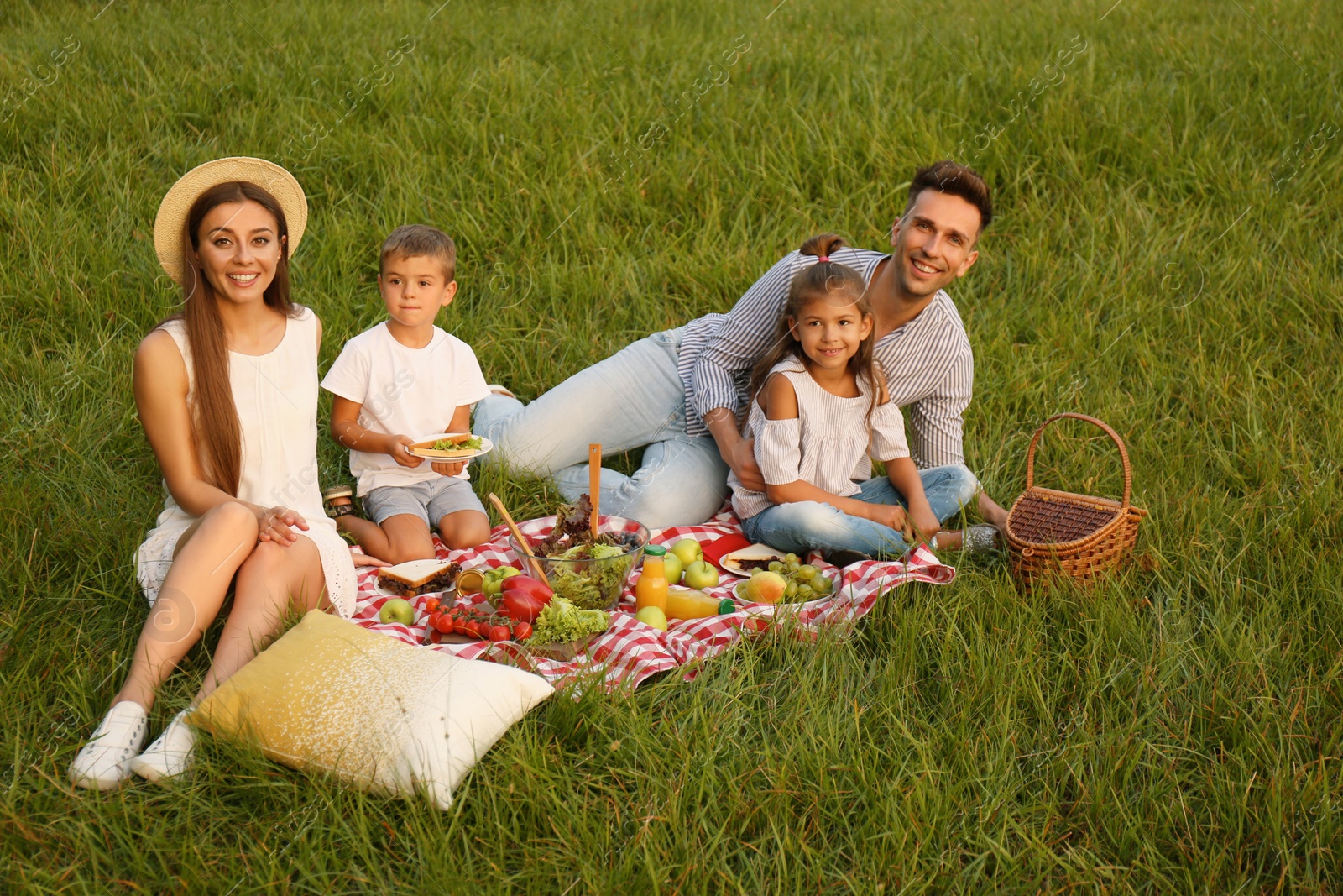 Photo of Happy family having picnic in park on summer day