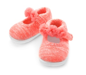 Photo of Pair of pink baby shoes on white background