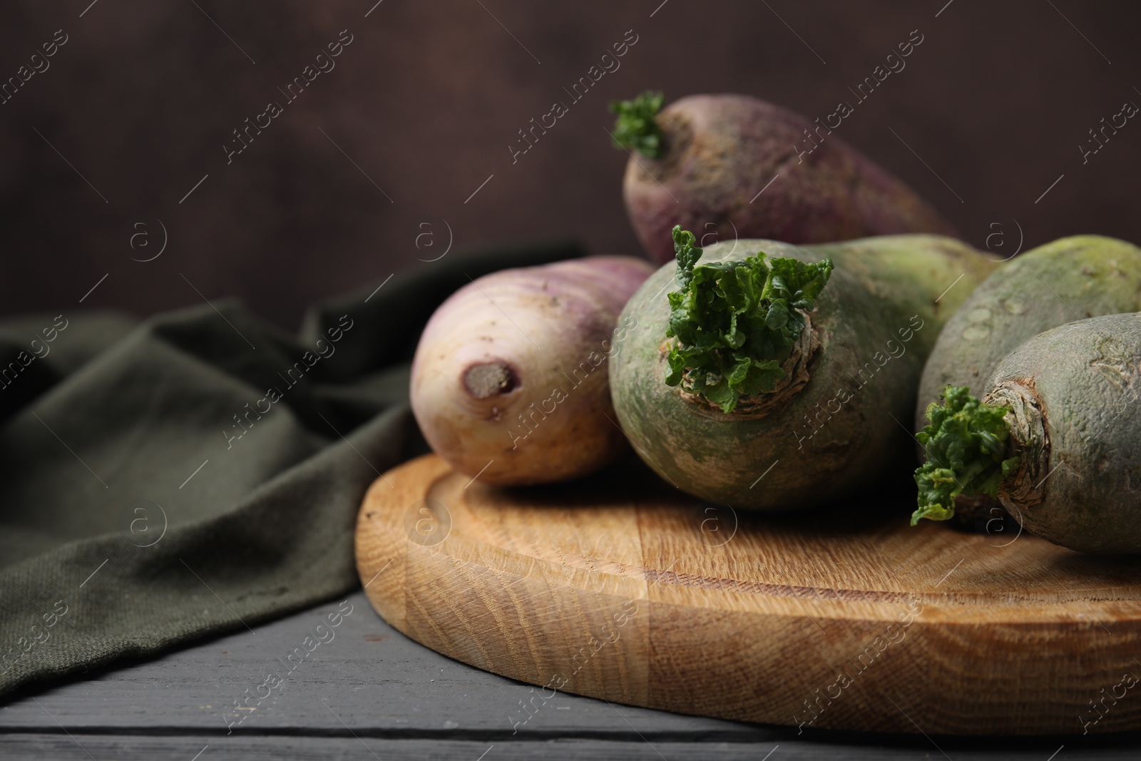 Photo of Green and purple daikon radishes on table, closeup