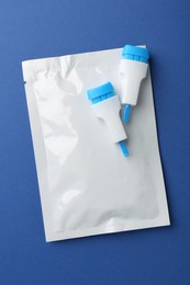 Photo of Disposable express test kit on blue background, flat lay