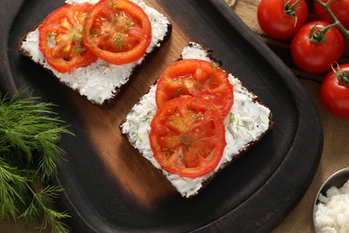 Delicious ricotta bruschettas with sliced tomatoes and dill on wooden table, flat lay