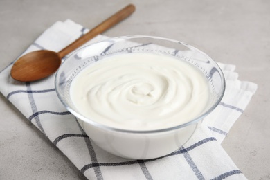 Glass bowl with creamy yogurt served on table