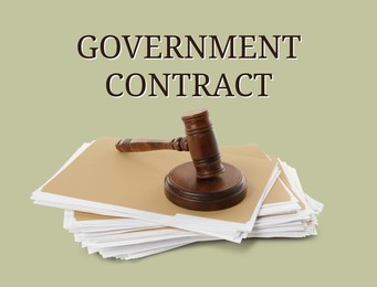 Image of Words Government Contract, wooden gavel and file folders with documents on light background