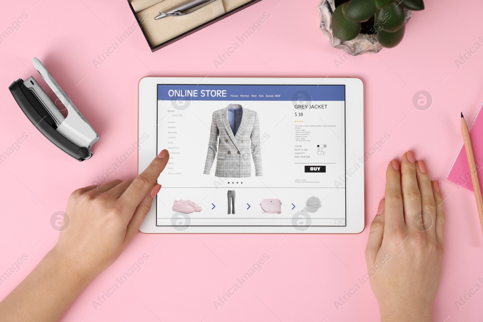 Photo of Woman with tablet shopping online on pink background, top view