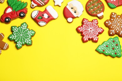 Photo of Different tasty Christmas cookies on yellow background, flat lay. Space for text
