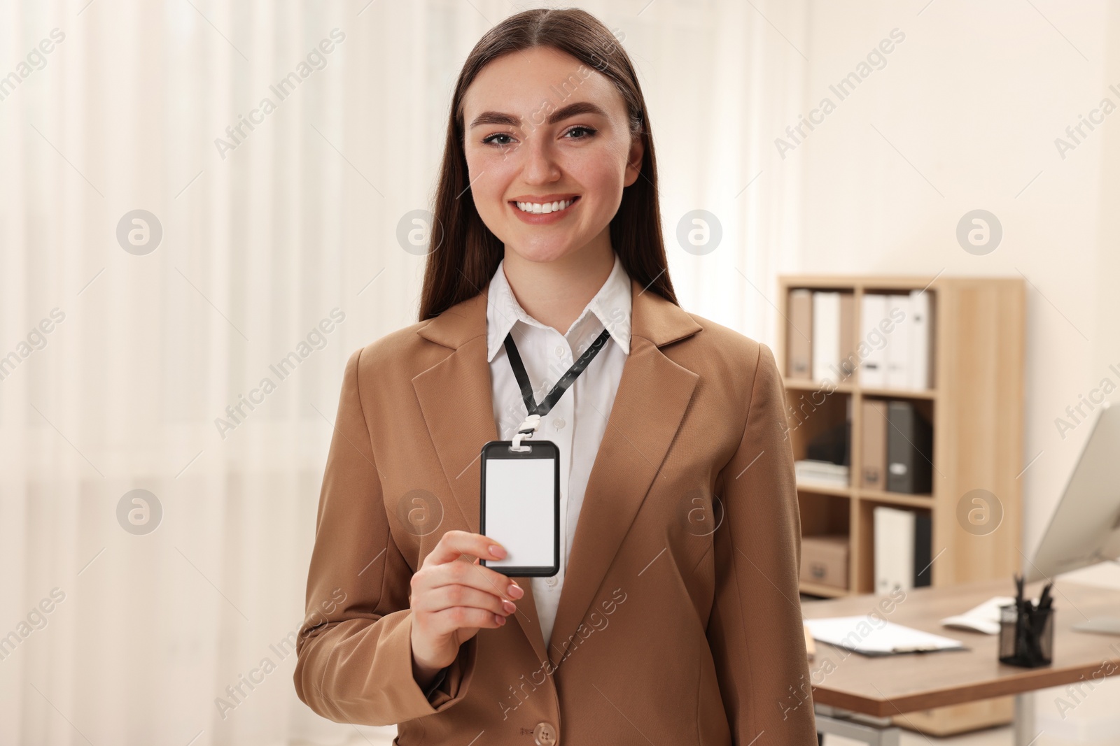 Photo of Happy woman with blank badge in office