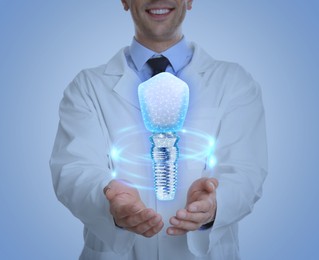 Doctor demonstrating virtual image of dental implant on light background, closeup