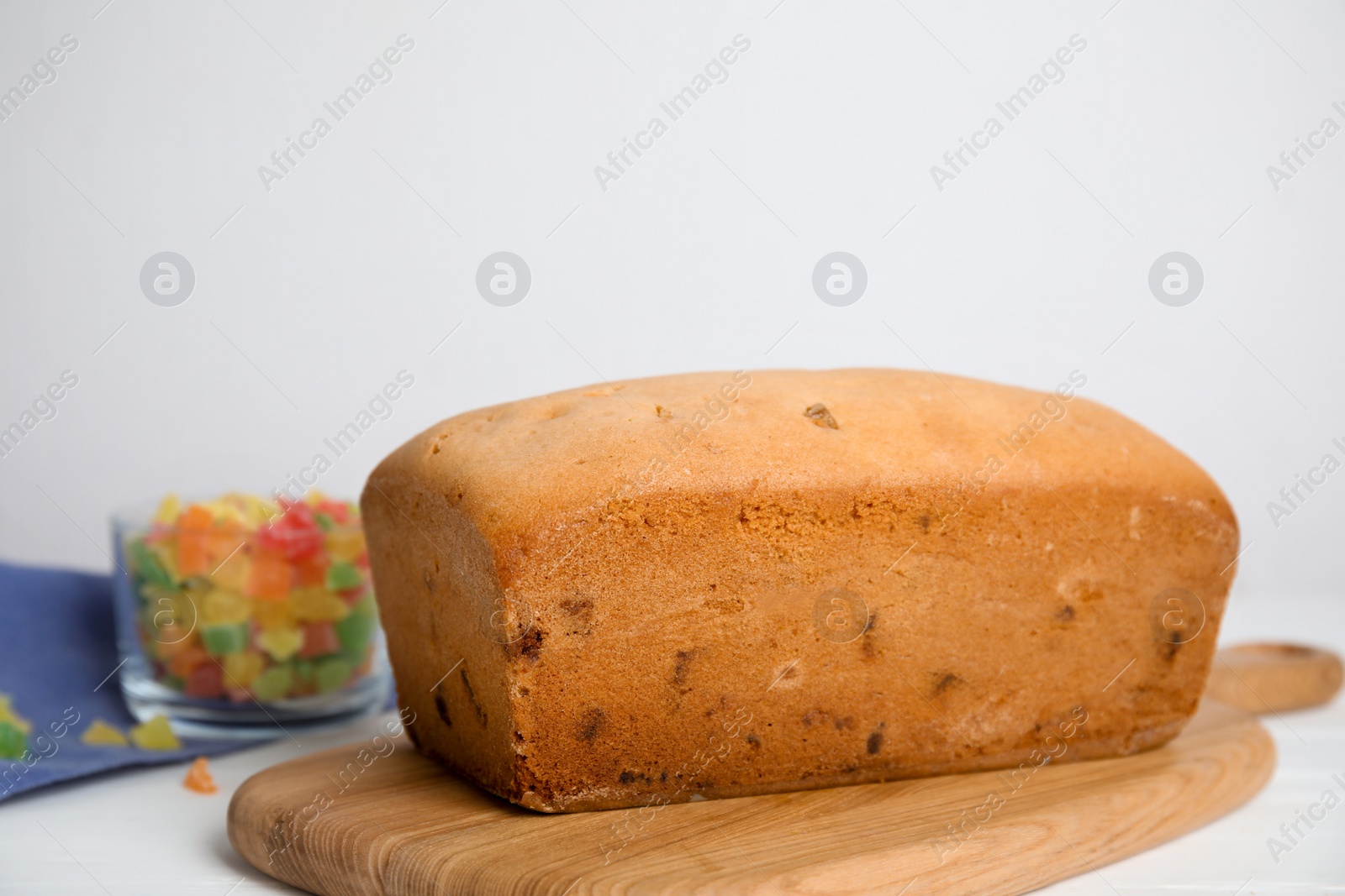 Photo of Delicious cake with candied fruits on white table