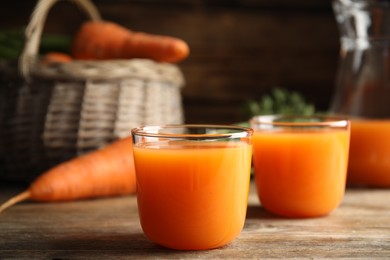 Freshly made carrot juice on wooden table