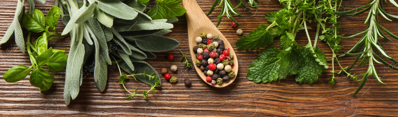 Image of Different fresh herbs and spices on wooden table, flat lay. Banner design