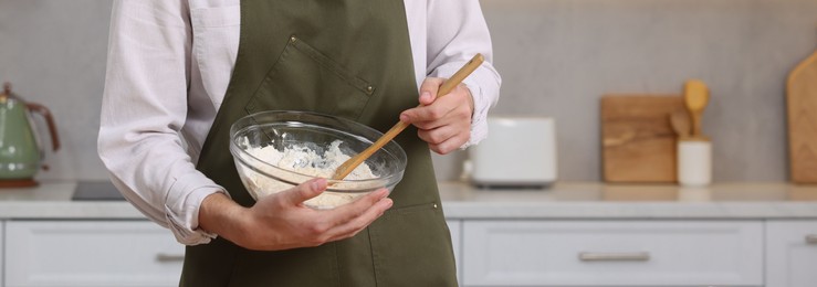 Photo of Making bread. Man preparing dough in bowl in kitchen, closeup. Space for text