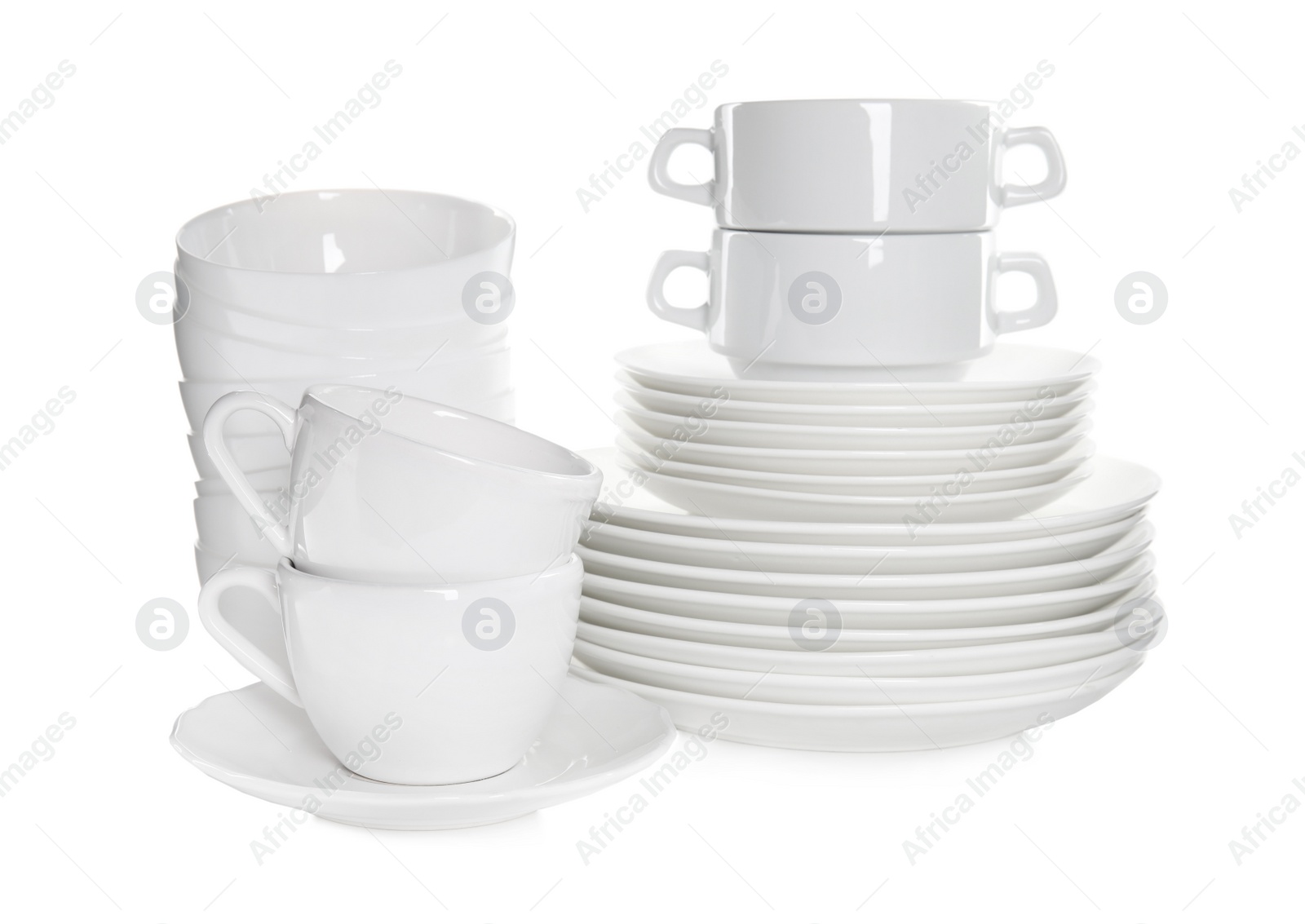 Photo of Stacked plates and cups on white background