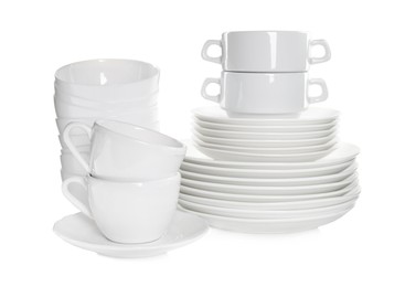 Photo of Stacked plates and cups on white background