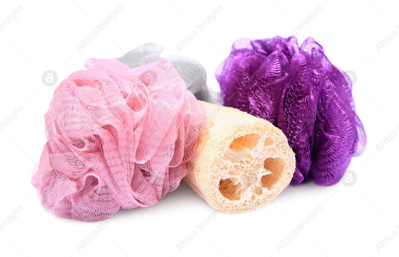 Photo of New shower puffs and loofah sponge on white background. Personal hygiene