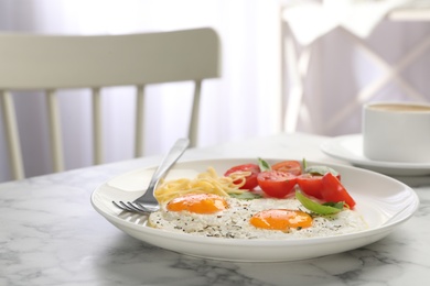 Photo of Tasty breakfast with fried eggs on marble table