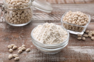 Photo of Bean flour and seeds on wooden table